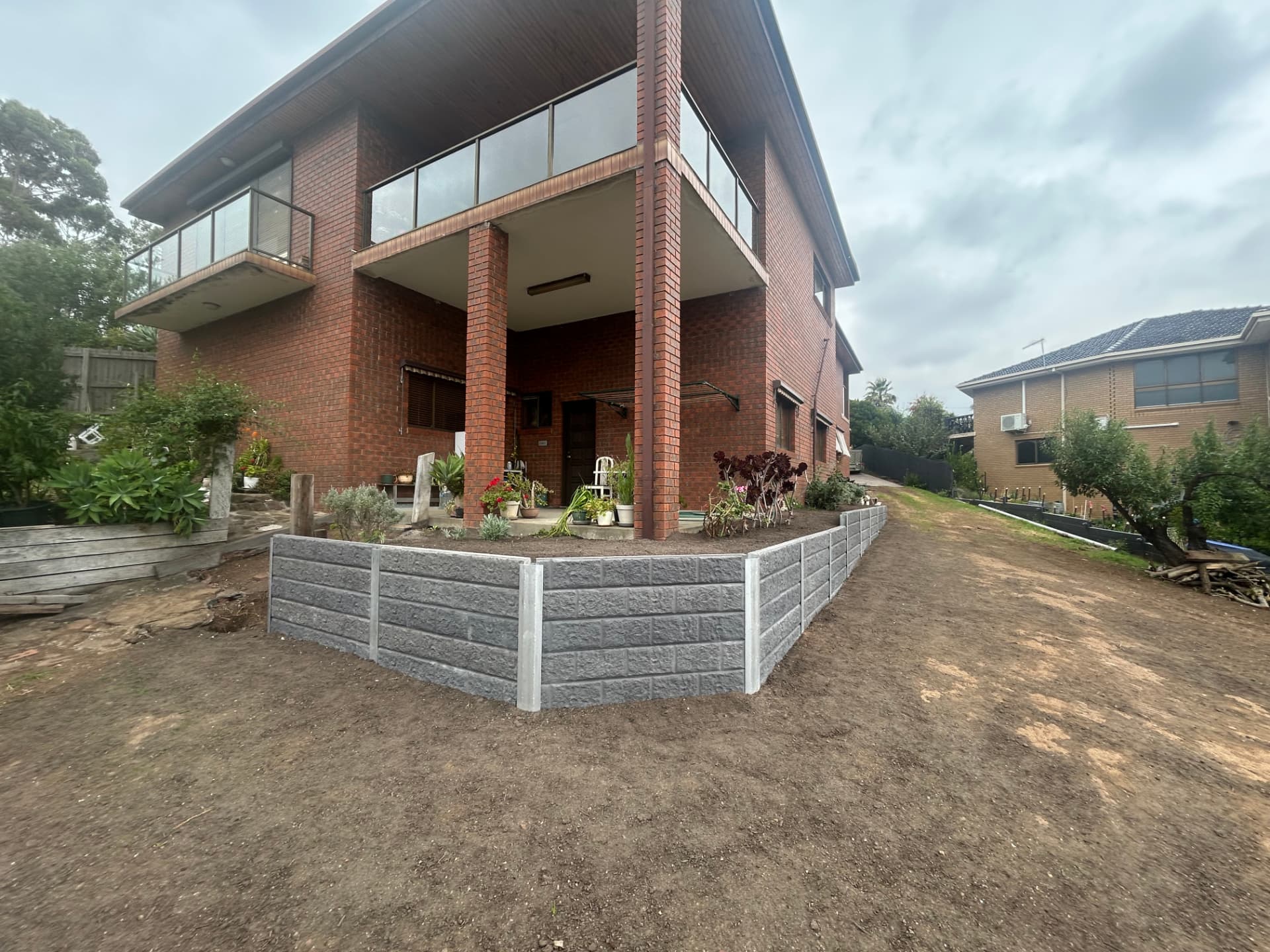 New concrete sleeper retaining wall with the yard graded level
