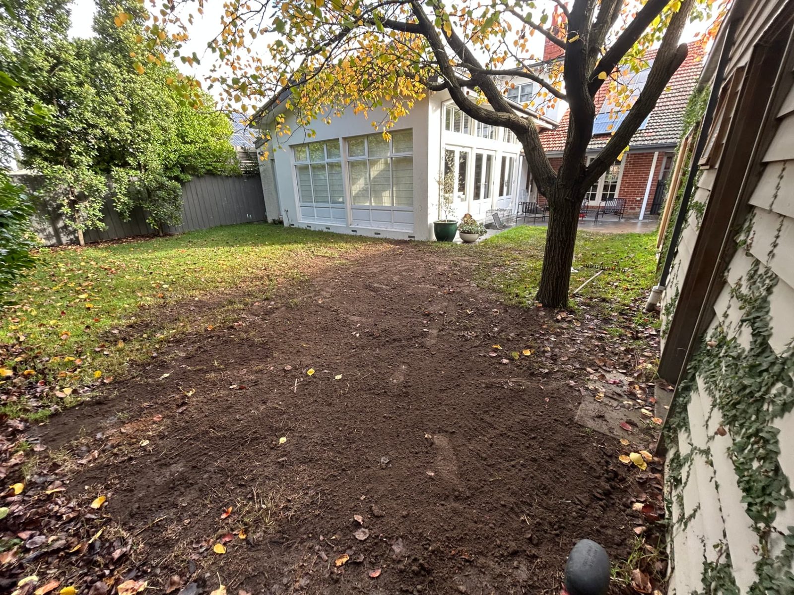 Lawn area backfilled and raked flat after trenching works