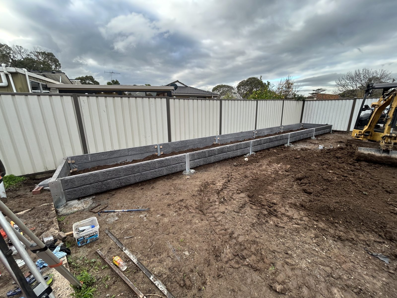Completed concrete sleeper retaining wall with the St Albans yard levelled and prepared